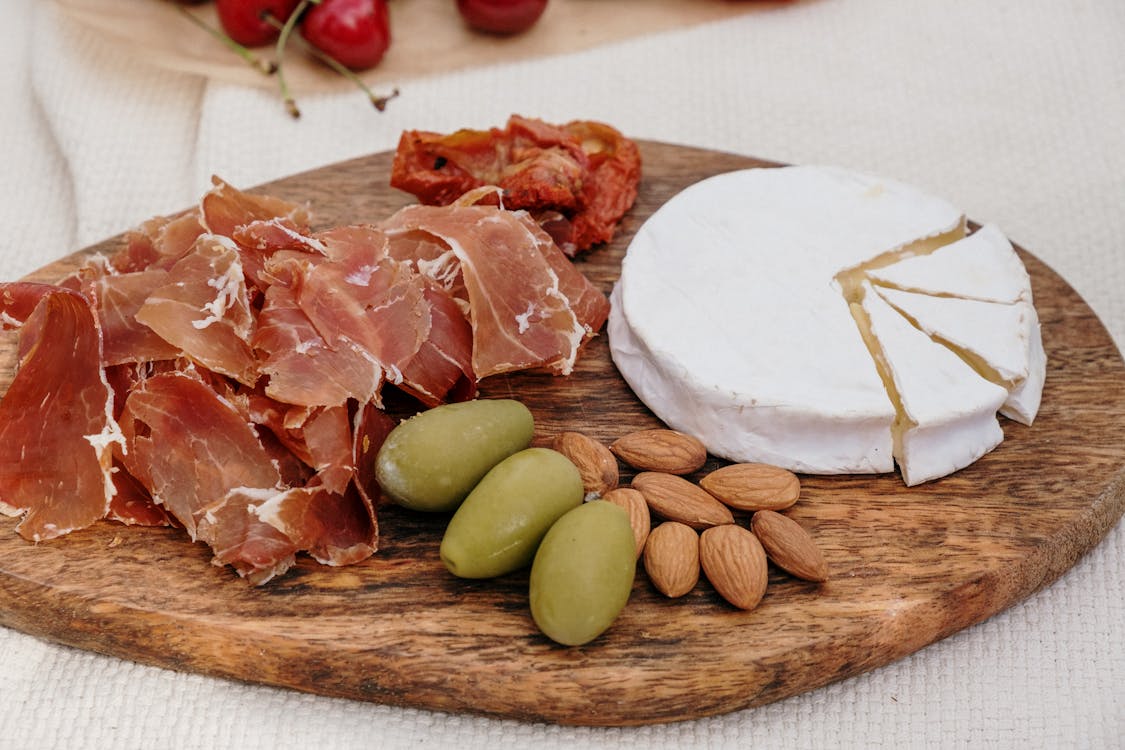 Les fromages crémeux et doux sont souvent servis avec du pain frais et un verre de vin blanc local,